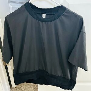 Athleta black top with ribbed collar and hem, size XS.